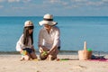 Happy Asian mother and her daughter playing sand together having fun and enjoying on the tropical beach in summer vacation Royalty Free Stock Photo