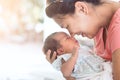 Happy asian mother hugging and kissing her newborn baby Royalty Free Stock Photo