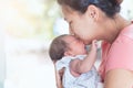 Happy asian mother hugging and kissing her newborn baby Royalty Free Stock Photo