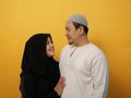 Happy Asian muslim couple hugging embracing each other, husband and wife love romance relationship over yellow Royalty Free Stock Photo