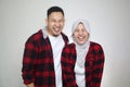 Happy Asian muslim couple, husband and wife looking at camera and posing sticking tongue out, happy cheerful expression Royalty Free Stock Photo