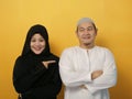 Happy Asian muslim couple proud of each other, pointing and smiling, lovefamily good relationship