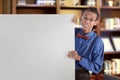 Happy asian nerdy man showing blank white board for copyspace