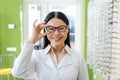 happy asian oculist adjusting eyeglasses 