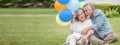 happy asian old couple holding balloons in the front lawn at home. senior man and elder woman Spend time together in backyard . Royalty Free Stock Photo