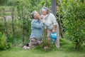 happy asian old couple watering the plants in the front lawn at home. senior man and elder woman Spend time together in backyard Royalty Free Stock Photo
