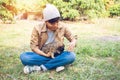 Happy Asian owner carrying, hugging Carrying adorable puppies dog her sitting green grass Royalty Free Stock Photo