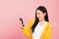 Happy Asian portrait beautiful cute young woman excited laughing holding mobile phone Royalty Free Stock Photo