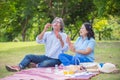 Retired couple blowing bubbles in park