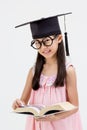 Happy Asian school kid graduate in graduation cap Royalty Free Stock Photo