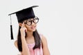 Happy Asian school kid graduate in graduation cap Royalty Free Stock Photo