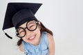 Happy Asian school kid graduate in graduation cap Royalty Free Stock Photo