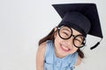 Happy Asian school kid graduate in graduation cap Royalty Free Stock Photo