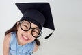 Happy Asian school kid graduate in graduation cap Royalty Free Stock Photo