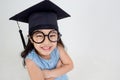 Happy Asian school kid graduate in graduation cap Royalty Free Stock Photo