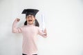 Happy Asian school kid graduate in graduation cap