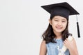 Happy Asian school kid graduate in graduation cap Royalty Free Stock Photo