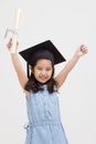 Happy Asian school kid graduate in graduation cap Royalty Free Stock Photo