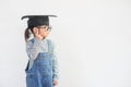 Happy Asian school kid graduate thinking with graduation cap Royalty Free Stock Photo