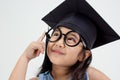 Happy Asian school kid graduate thinking Royalty Free Stock Photo