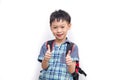 Happy Asian schoolboy wearing backpack and giving thumbs up Royalty Free Stock Photo