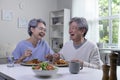 Asian senior couple eating meal together in kitchen at home. Retirement senior couple lifestyle living concept Royalty Free Stock Photo