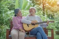 Asian senior couple elderly man playing guitar while his wife singing together Royalty Free Stock Photo