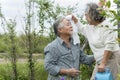 Happy and fun asian senior couple is enjoy life with health care for plants trees at outdoor garden after retirement lifestyle Royalty Free Stock Photo