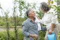 asian senior couple is Happy enjoy life with health care for plants trees at outdoor garden after retirement lifestyle Royalty Free Stock Photo