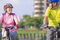 Happy  Asian senior couple exercising with bicycles in the city park Royalty Free Stock Photo