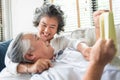 Happy Asian senior couple in love hugging and laughing enjoying life and spending time together at home Royalty Free Stock Photo