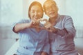 Happy asian senior couple showing hands heart shape together,Happy and smiling,Positive thinking Royalty Free Stock Photo