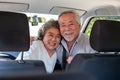 Happy Asian senior couple sitting in car and driving car on journey trip.