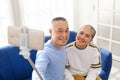 Happy Asian senior couple smile and take selfies photos and videos with smart phone and selfie stick together. Royalty Free Stock Photo