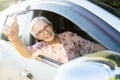 Happy asian senior female driver with a smiling in her car, enjoying traveling during retirement age,healthy old people feel fun, Royalty Free Stock Photo