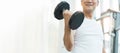 Happy Asian Senior Fitness man lifting dumbbell while exercise at the gym Royalty Free Stock Photo