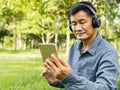 Happy asian senior man Headphones Listening Music Royalty Free Stock Photo
