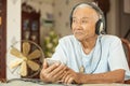 Happy asian senior man Headphones Listening Music Royalty Free Stock Photo