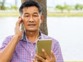 Happy Asian senior man listening Music Royalty Free Stock Photo