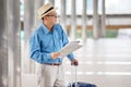 happy asian Senior man tourists   sightseeing with map and searching destination in urban city outdoors.  old Travellers lifestyle Royalty Free Stock Photo