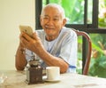 Happy asian senior man using the mobile phone Royalty Free Stock Photo