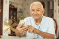 Happy asian senior man using the mobile phone Royalty Free Stock Photo