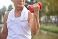 Asian Senior man lifting dumbbell. Royalty Free Stock Photo