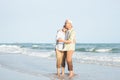 Happy Asian senior man and woman couple smile dancing resting relax on the beach Royalty Free Stock Photo