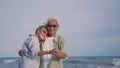 Happy Asian senior man and woman couple smile dancing resting relax on the beach Royalty Free Stock Photo