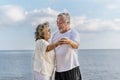 Happy asian senior retired couple relax smiling elder man and woman enjoying with retired vacation at sea beach outdoor. Health Royalty Free Stock Photo