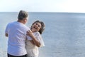 Happy asian senior retired couple relax smiling elder man and woman enjoying with retired vacation at sea beach outdoor. Health Royalty Free Stock Photo