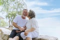 Happy and smiling asian senior retired couple, elder man and woman enjoying with retired vacation at sea beach outdoor. Health Royalty Free Stock Photo