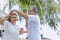 Asian senior retired couple, relax smiling elder man and woman enjoying with retired vacation at sea beach outdoor. Health Royalty Free Stock Photo