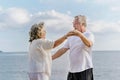 Happy asian senior retired couple relax smiling elder man and woman enjoying with retired vacation at sea beach outdoor. Health Royalty Free Stock Photo